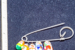 Helen Paddle jewelry Christmas brooch five little stacking dolls on large safety pin